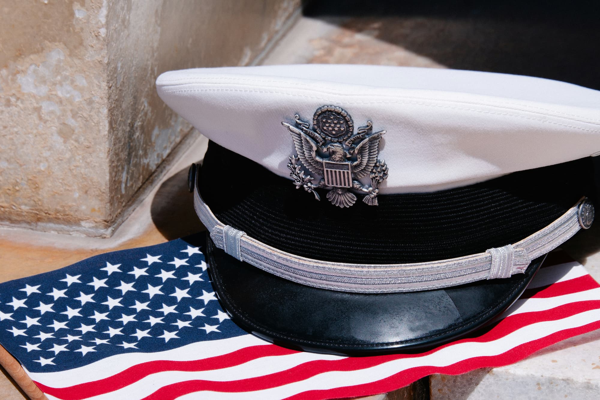 Military hat resting on an American flag.