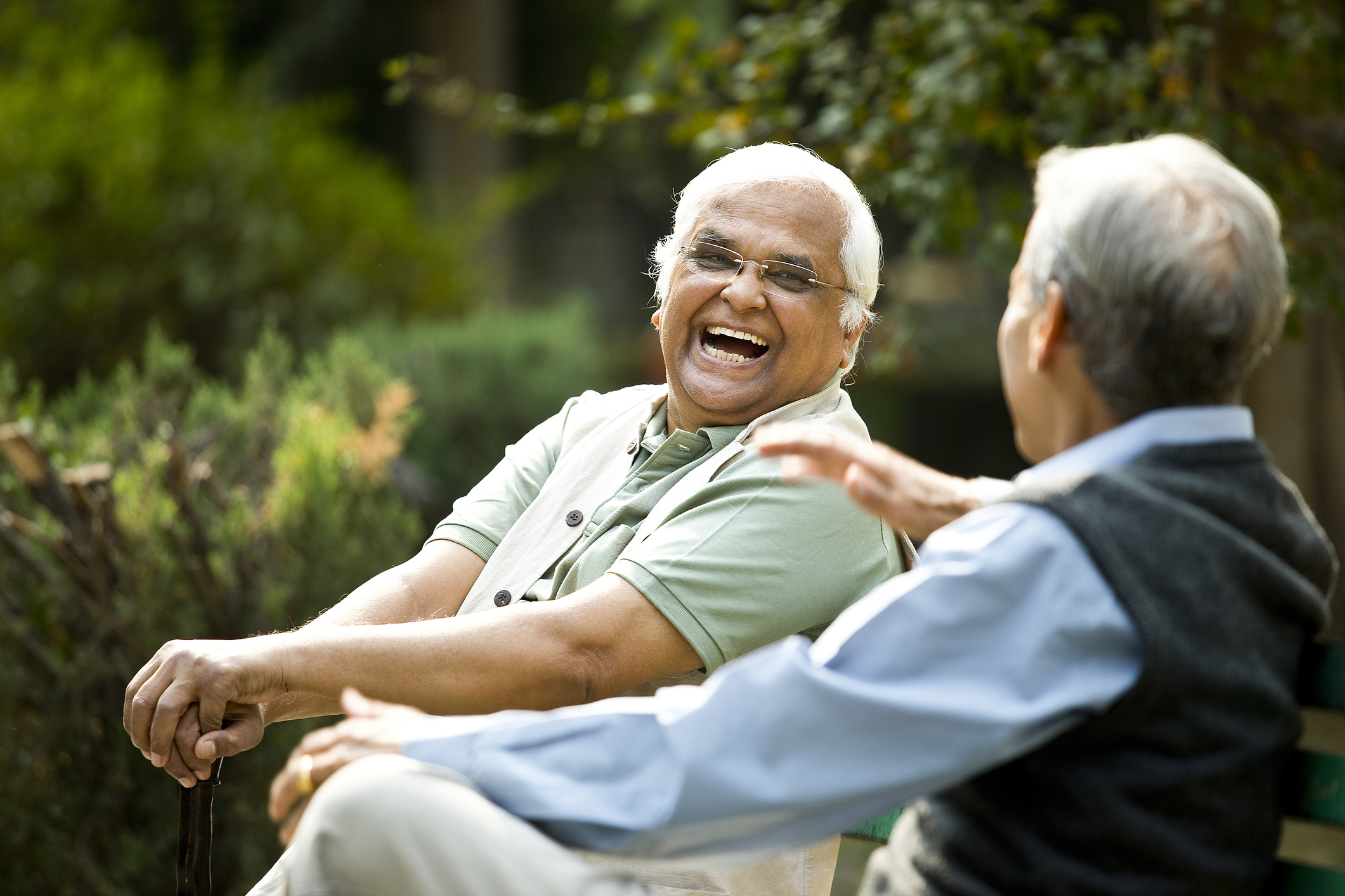 Two Senior men laughing outside