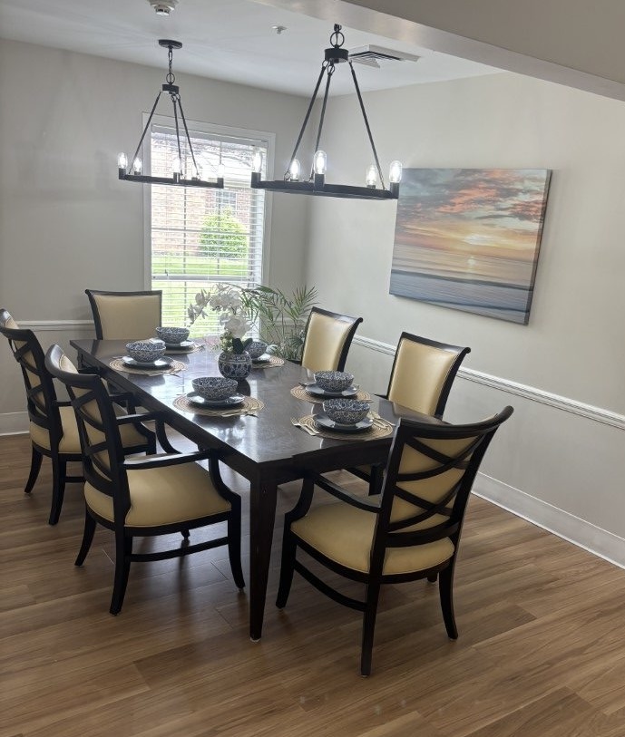 Image showing the beautifully set, cherry dining table and chairs at South Knoxville Senior Living