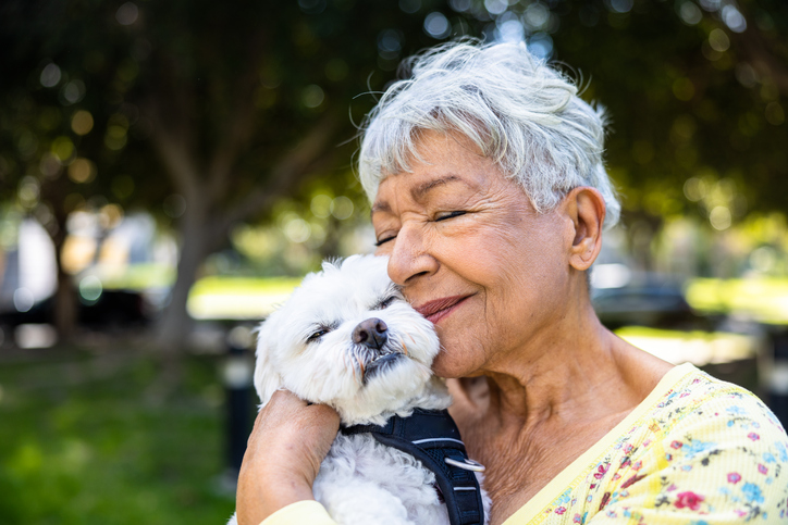 a senior adult female and her dog enjoying the outdoors
