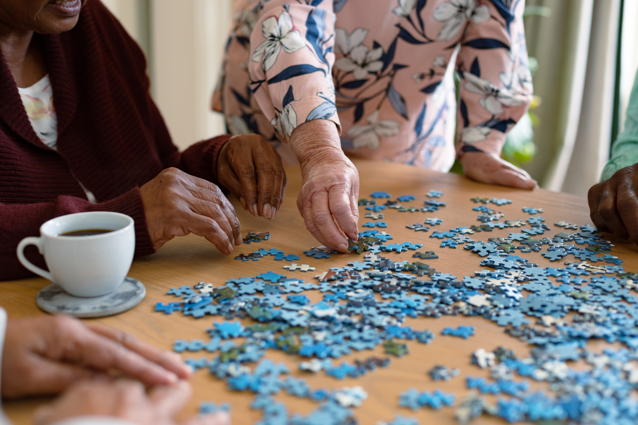 Senior adults building a puzzle.