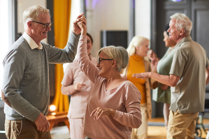 Group of happy seniors socializing at a senior living community event