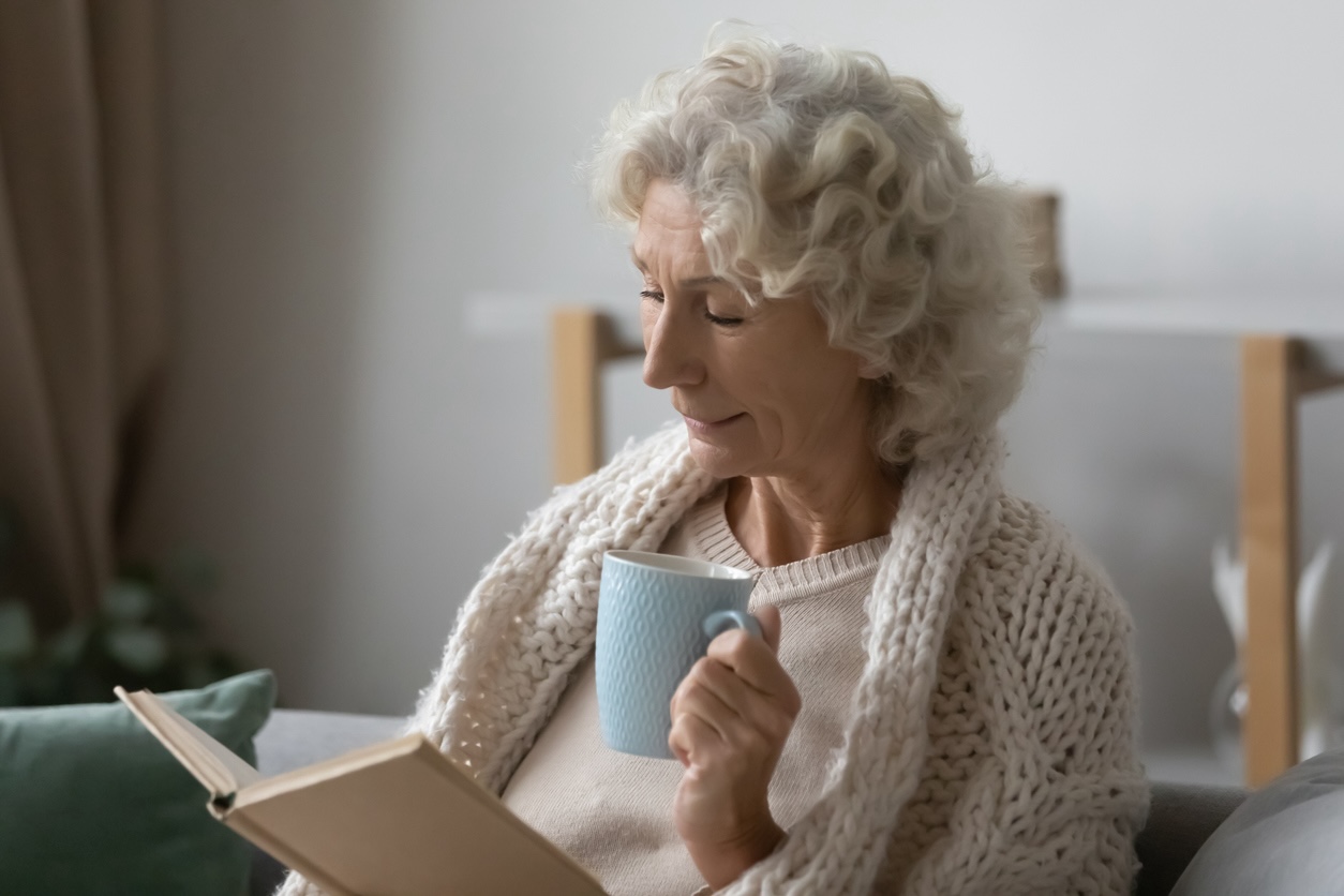 Senior staying warm indoors while preparing for winter storms