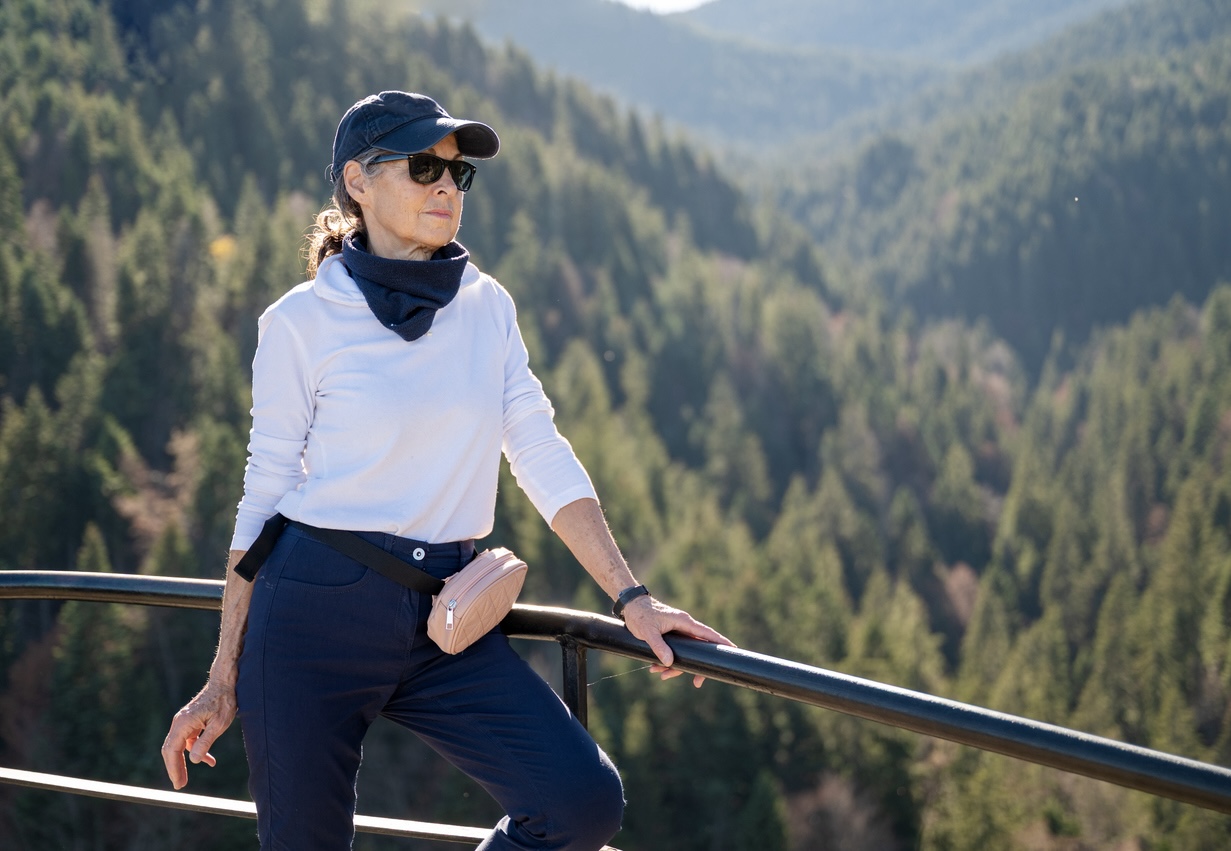 Senior adult woman enjoying mountain views from a scenic overlook