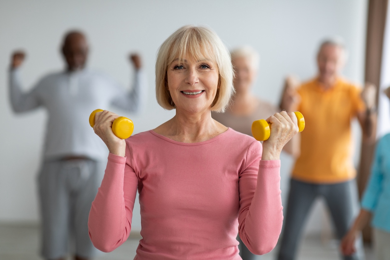 Senior adult woman participating in a group fitness activity supporting heart health
