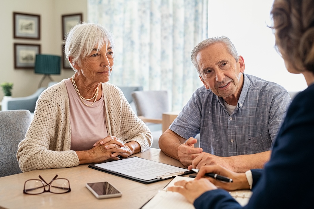 Senior adult couple asking questions during a senior living community tour