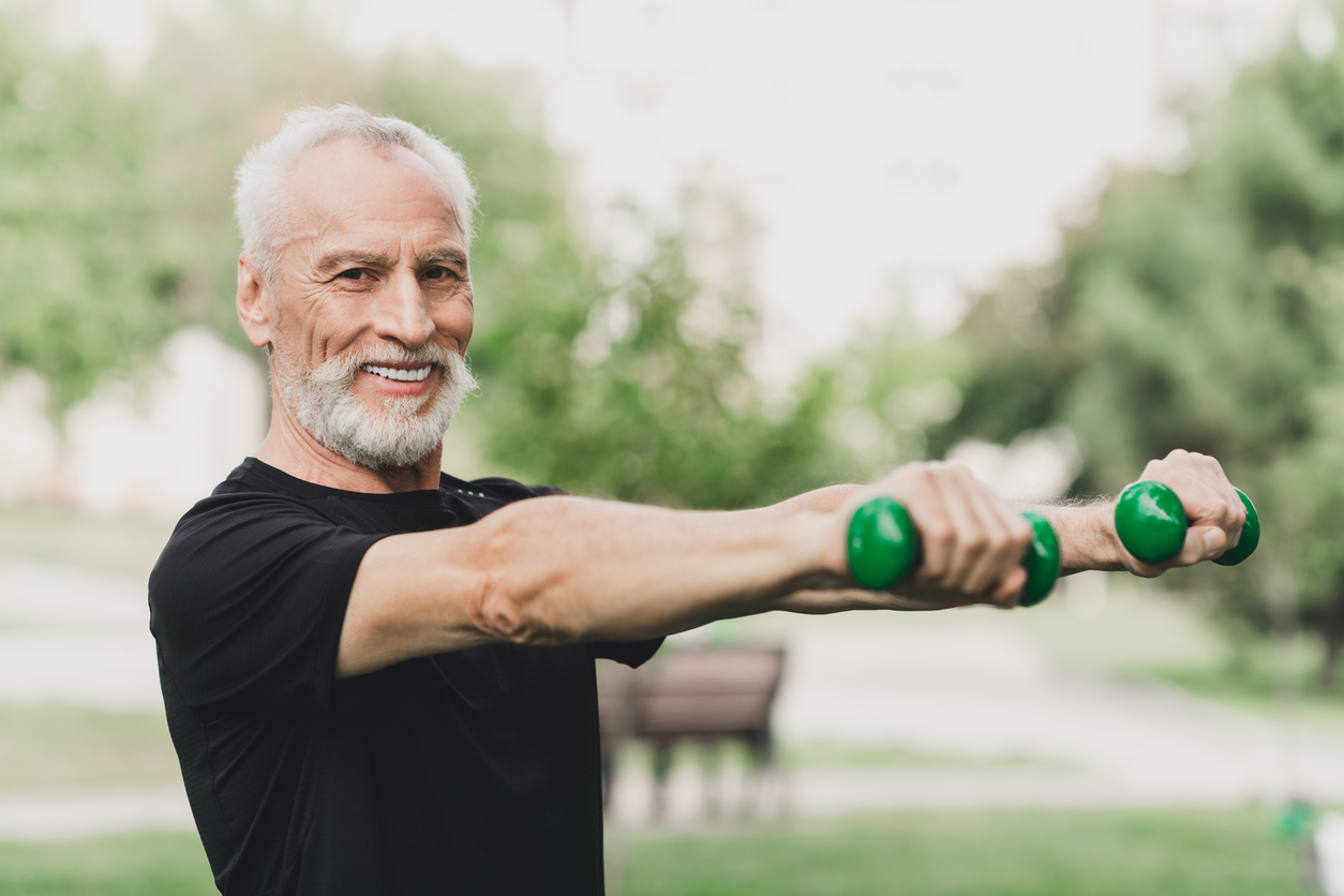 Senior adult exercising outdoors safely during warm weather