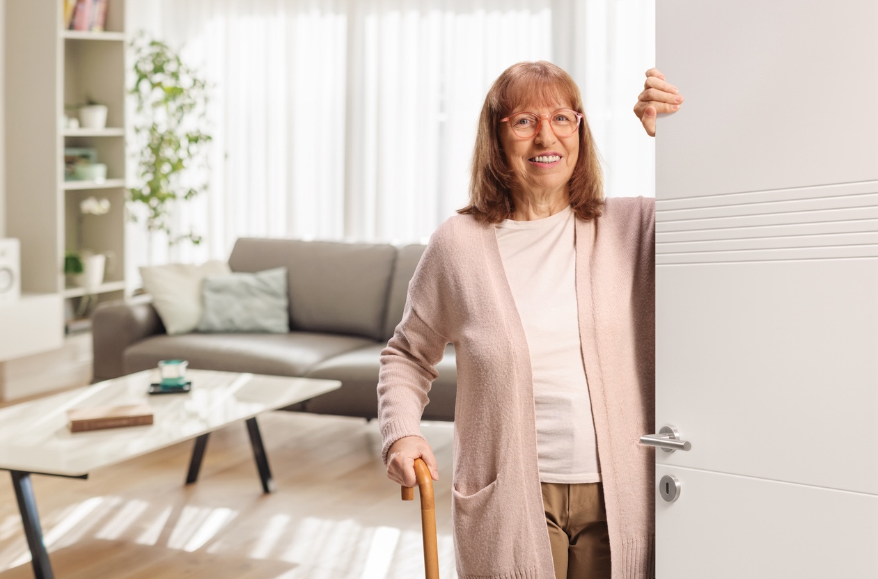 Senior adult entering a comfortable senior living suite