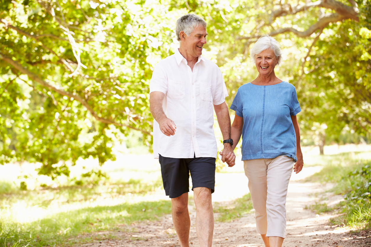 Senior couple enjoying a walk outdoors during allergy season
