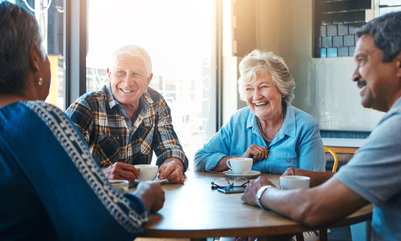 Senior adults enjoying coffee and conversation during an indoor outing