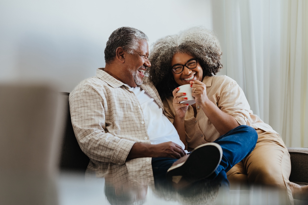 Senior couple enjoying coffee and conversation in a comfortable home setting