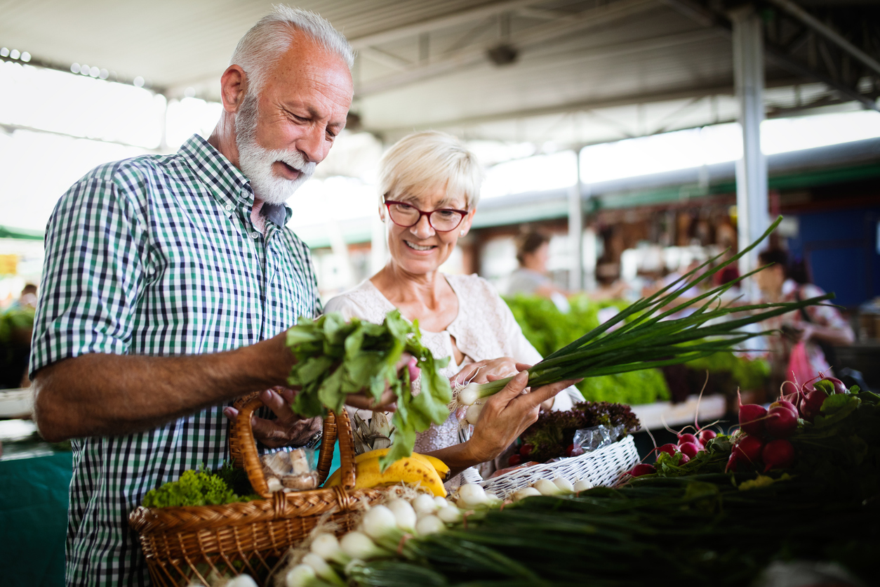 Senior couple shopping for fresh produce at a farmers market