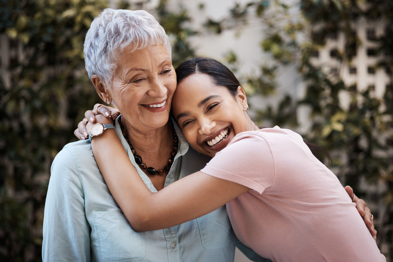 Senior mother and adult daughter embracing and spending time together
